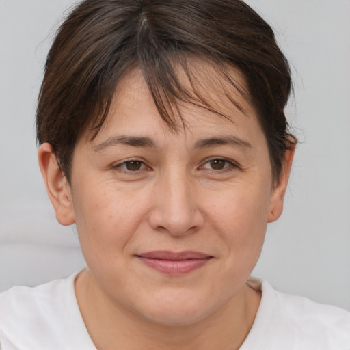 Joyful white adult female with short  brown hair and brown eyes