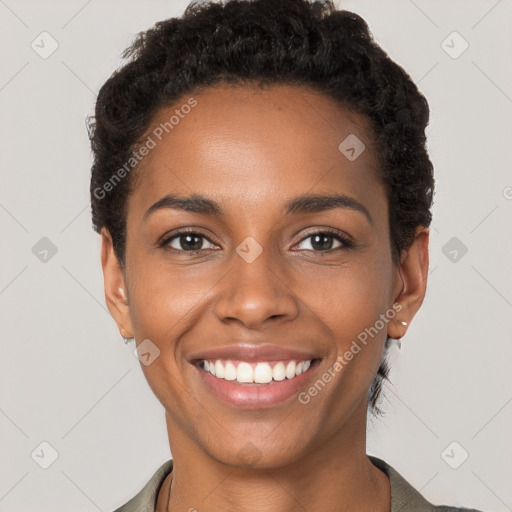 Joyful black young-adult female with short  brown hair and brown eyes