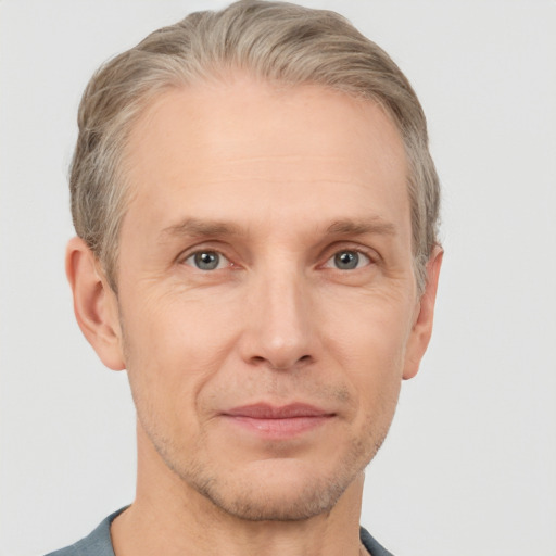 Joyful white adult male with short  brown hair and grey eyes