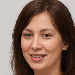 Joyful white adult female with long  brown hair and brown eyes