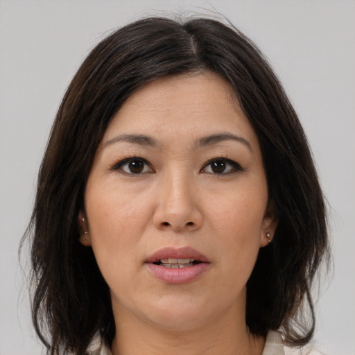 Joyful white adult female with medium  brown hair and brown eyes