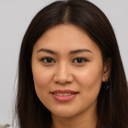 Joyful white young-adult female with long  brown hair and brown eyes
