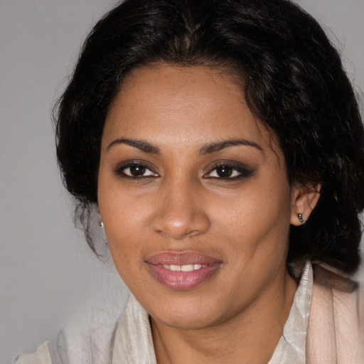 Joyful black young-adult female with medium  brown hair and brown eyes