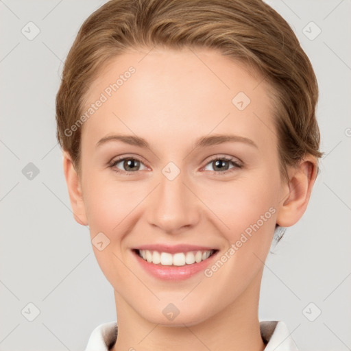 Joyful white young-adult female with short  brown hair and grey eyes