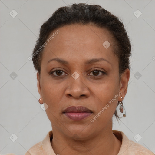 Joyful black adult female with short  brown hair and brown eyes