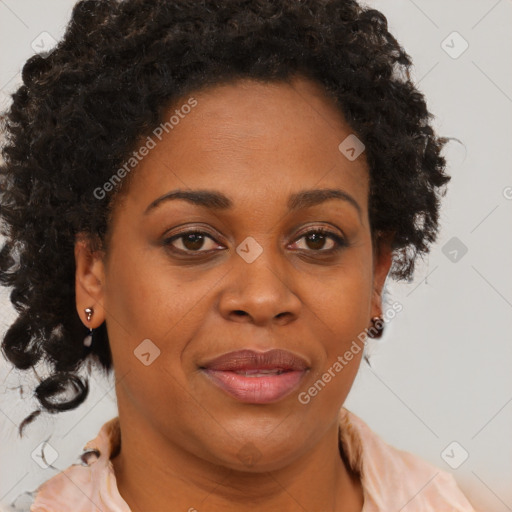 Joyful black adult female with medium  brown hair and brown eyes