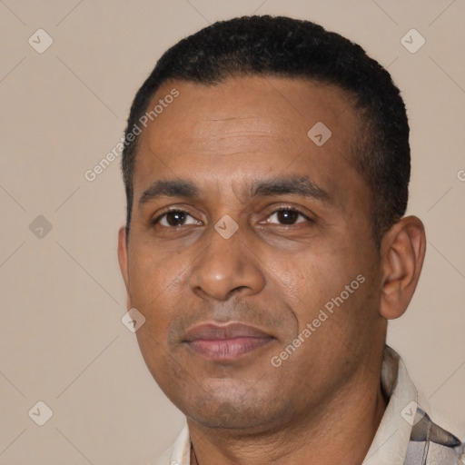 Joyful black adult male with short  black hair and brown eyes