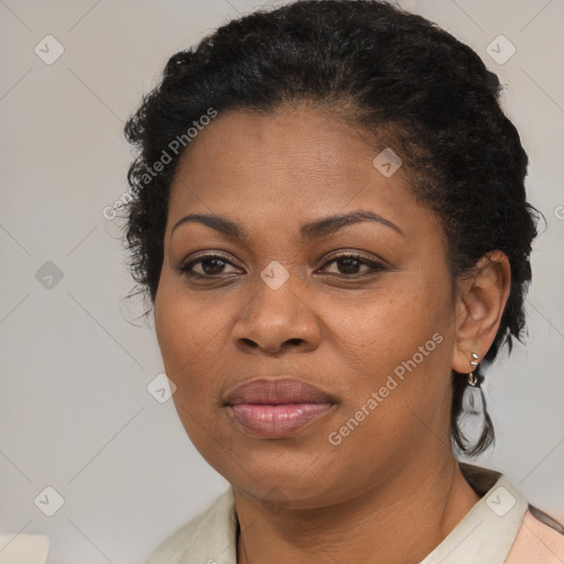 Joyful black adult female with medium  brown hair and brown eyes