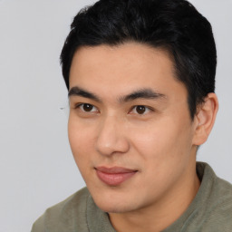 Joyful asian young-adult male with short  black hair and brown eyes