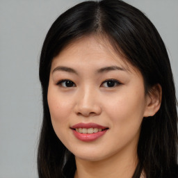 Joyful asian young-adult female with long  brown hair and brown eyes