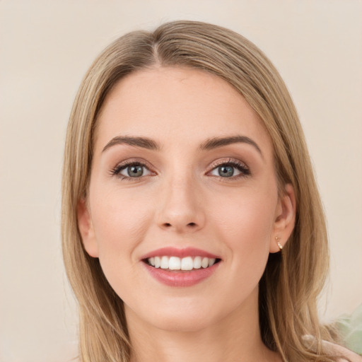 Joyful white young-adult female with long  brown hair and green eyes