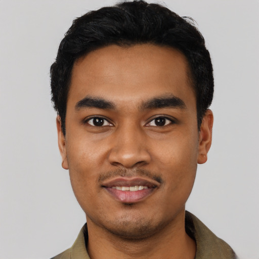 Joyful latino young-adult male with short  black hair and brown eyes