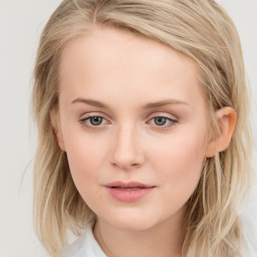 Joyful white young-adult female with medium  brown hair and blue eyes