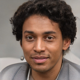 Joyful black young-adult male with short  brown hair and brown eyes