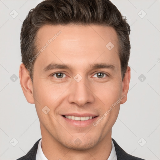 Joyful white young-adult male with short  brown hair and grey eyes