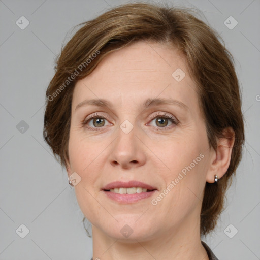 Joyful white adult female with medium  brown hair and grey eyes