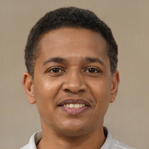 Joyful latino young-adult male with short  brown hair and brown eyes