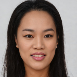 Joyful asian young-adult female with long  brown hair and brown eyes