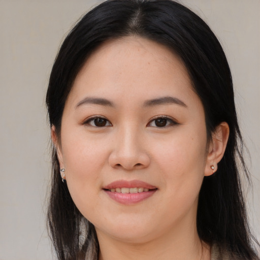 Joyful asian young-adult female with long  black hair and brown eyes