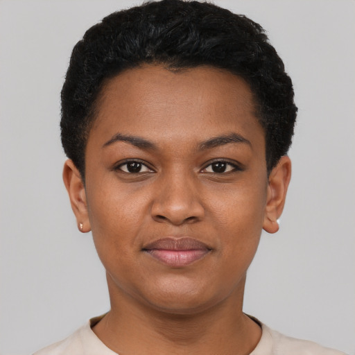Joyful black young-adult female with short  black hair and brown eyes