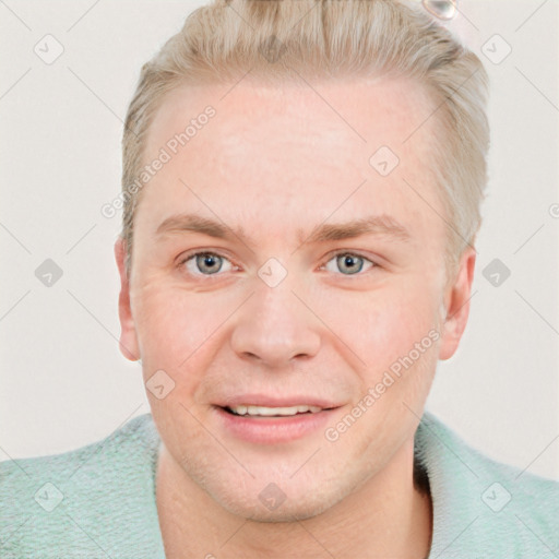 Joyful white young-adult male with short  brown hair and blue eyes