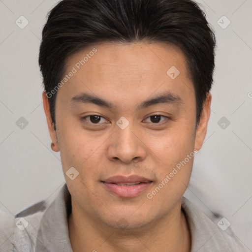 Joyful asian young-adult male with short  brown hair and brown eyes