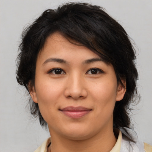 Joyful asian young-adult female with medium  brown hair and brown eyes