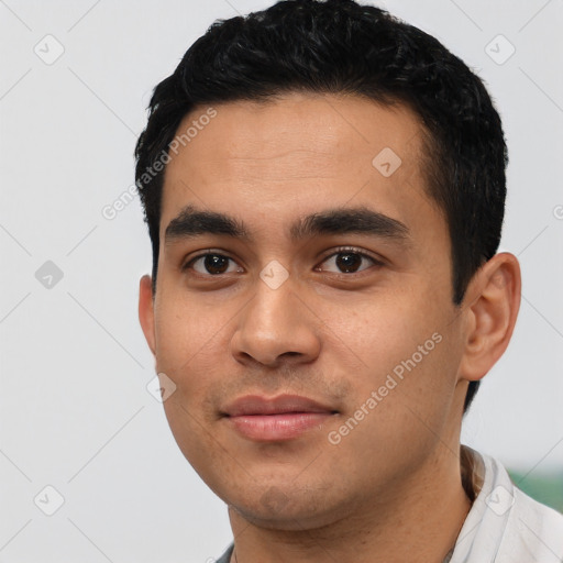 Joyful latino young-adult male with short  black hair and brown eyes