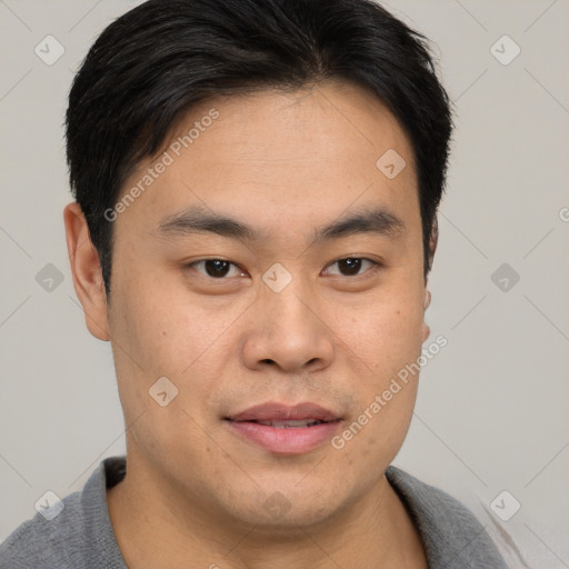 Joyful asian young-adult male with short  brown hair and brown eyes