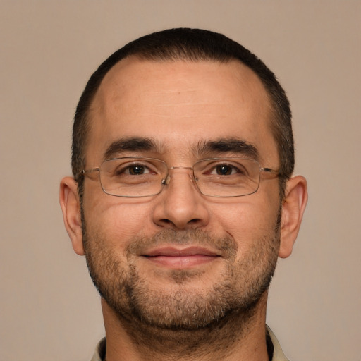 Joyful white adult male with short  brown hair and brown eyes