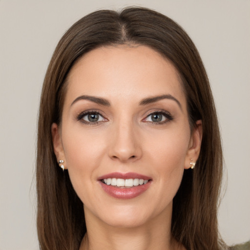 Joyful white young-adult female with long  brown hair and brown eyes