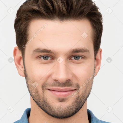 Joyful white young-adult male with short  brown hair and grey eyes