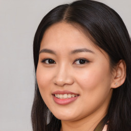 Joyful asian young-adult female with long  brown hair and brown eyes