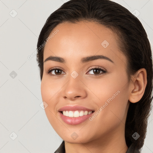 Joyful white young-adult female with long  brown hair and brown eyes