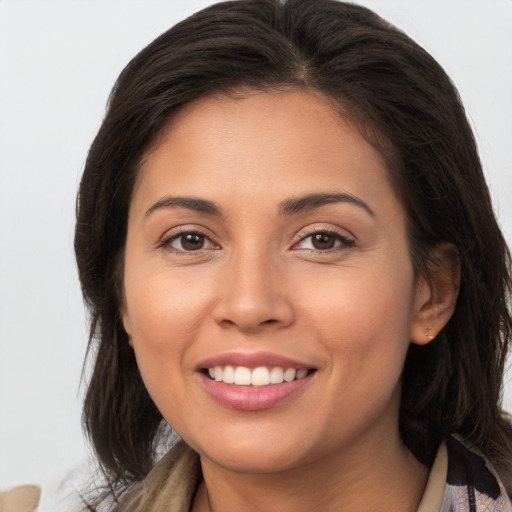 Joyful white young-adult female with long  brown hair and brown eyes