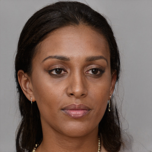 Neutral black young-adult female with long  brown hair and brown eyes