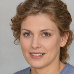 Joyful white young-adult female with medium  brown hair and blue eyes