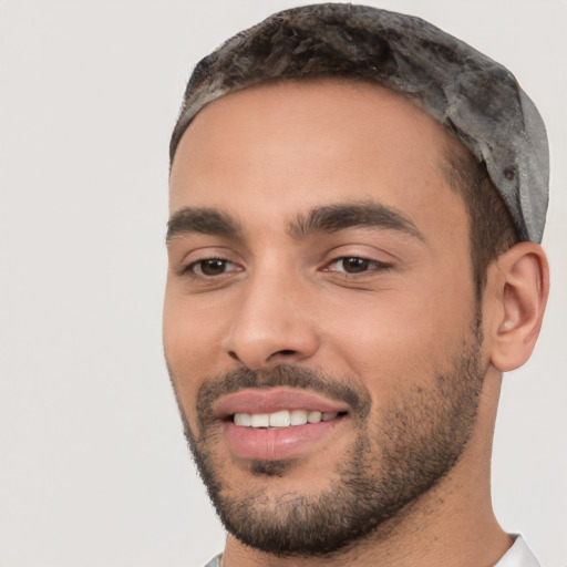 Joyful white young-adult male with short  black hair and brown eyes