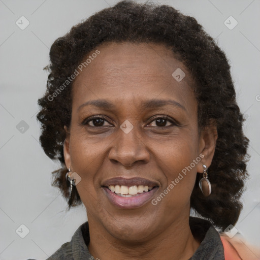 Joyful black adult female with medium  brown hair and brown eyes