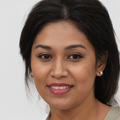 Joyful asian young-adult female with long  brown hair and brown eyes