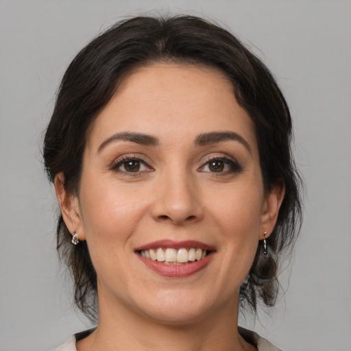 Joyful white young-adult female with medium  brown hair and brown eyes