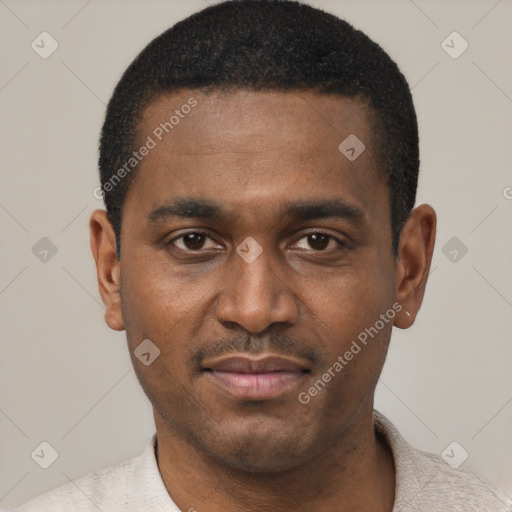 Joyful black young-adult male with short  black hair and brown eyes
