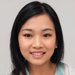 Joyful asian young-adult female with medium  black hair and brown eyes