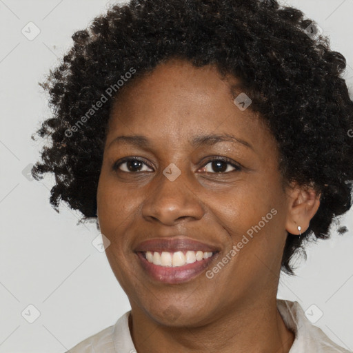 Joyful black adult female with short  brown hair and brown eyes