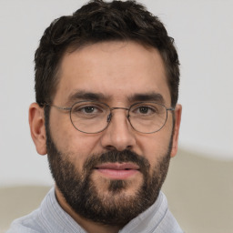 Joyful white adult male with short  brown hair and brown eyes