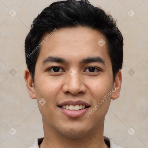 Joyful latino young-adult male with short  black hair and brown eyes