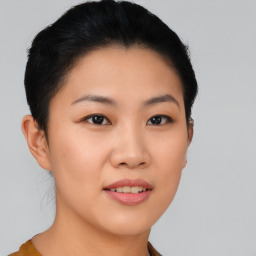 Joyful asian young-adult female with short  black hair and brown eyes