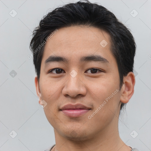 Joyful asian young-adult male with short  black hair and brown eyes