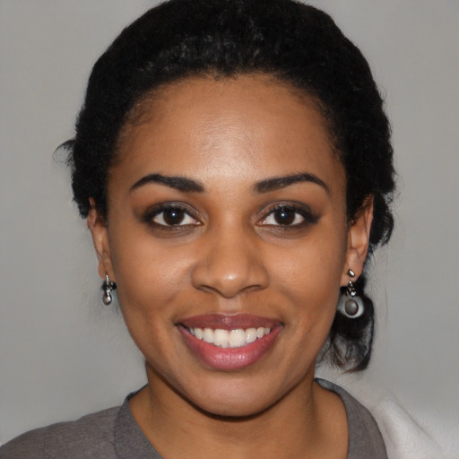 Joyful latino young-adult female with medium  black hair and brown eyes