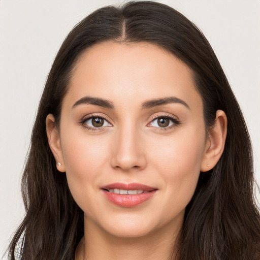 Joyful white young-adult female with long  brown hair and brown eyes